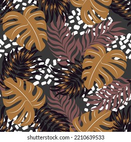 Abstract seamless tropical pattern with bright plants and leaves on a gray background. Beautiful print with hand drawn exotic plants. Tropic leaves in bright colors.