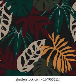 Abstract seamless tropical pattern with dark colorful leaves on black background. Seamless exotic pattern with tropical plants. Exotic wallpaper. 