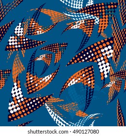 Abstract seamless urban background. Repeated backdrop for boys, guys, sport, textile. Chaotic grunge geometric pattern with orange and white dots, texture and directing arrow.Creative Original design.