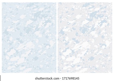 Abstract Seamless Vector Patterns with Freehand Brush Stains. Blue and Gray Camouflage Print. Light Gray and Pastel Blue Backgrounds. Stone Backdrop. Pale Color Vector Blanks.