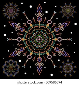 Abstract set of floral elements. Vector winter snowflakes on black background in blue and orange colors.