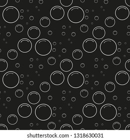 Abstract shiny bubbles on a black background.