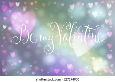 Abstract smooth blur background with heart-shaped lights over it and hand written Valentine's day greetings.