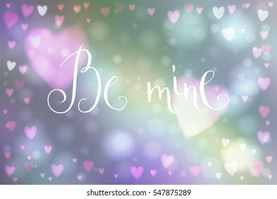 Abstract smooth blur background with heart-shaped lights over it and hand written Valentine's day words.