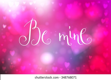 Abstract smooth blur pink background with heart-shaped lights over it and hand written Valentine's day words.