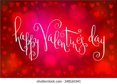 Abstract smooth blur red background with heart-shaped lights over it and hand written Valentine's day greetings.
