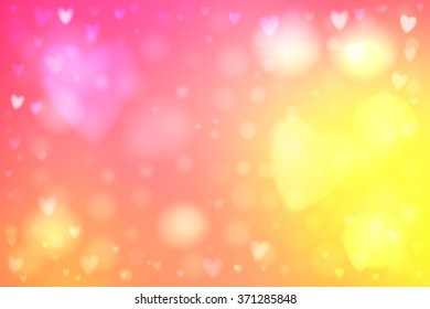 Abstract smooth blur yellow and pink background with heart-shaped lights over it.