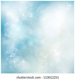 Abstract soft blurry background with bokeh lights and stars in soft blues. The festive feeling makes it a great backdrop for many winter, Christmas designs. Copyspace.