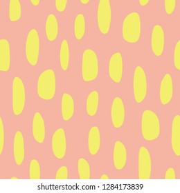 Abstract spot shapes seamless vector pattern. Yellow lime marks on coral background. Modern strokes design for fabric, packaging , digital paper, web banner, page fill, wrapping, covers