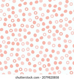 Abstract spotted seamless pattern in pastel colors. Pink dotted background. Vector hand-drawn illustration. Perfect for print, decorations, wrapping paper, covers, invitations, cards.
