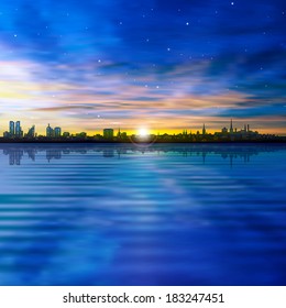 abstract sunset background with silhouette of city and clouds