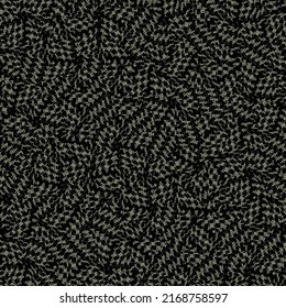 Abstract textile fabric made of patches with a texture of tiny dashes and squares. Mottled background in black and blue gray.