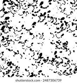 Abstract texture of black mascara splatters on a white background.