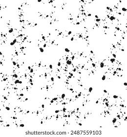 Abstract texture of black mascara splatters on a white background.