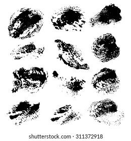 Abstract texture smears of black dry paint spots on white paper