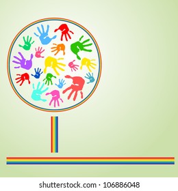 Abstract tree from multi-coloured prints of hands and a rainbow