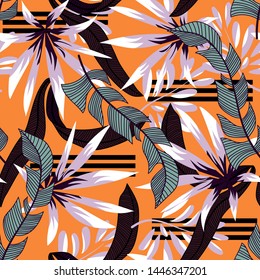 Abstract tropical seamless pattern with colorful leaves and bright plants on orange background. Vector design. Jungle print. Floral background. Printing and textiles. Exotic tropics. Fresh design.
