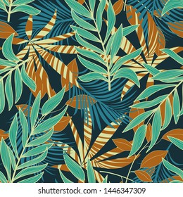 Abstract tropical seamless pattern with colorful leaves and bright plants on blue background. Vector design. Jungle print. Floral background. Printing and textiles. Exotic tropics. Fresh design.