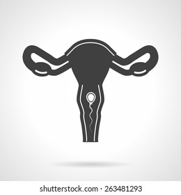 Abstract vector icon with black silhouette uterine with white spermatozoon for gynecology on white background.