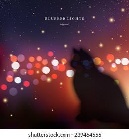 Abstract vector illustration.  Blurred silhouette of a cat on a background of the night city lights and sky.