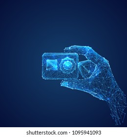 Abstract vector image of action camera in hand . Low poly wire frame illustration. Lines and dots. RGB Color mode. Video blog concept. Polygonal art.