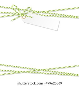 Abstract white background with tag label tied up with green rope bakers twine bow and ribbons