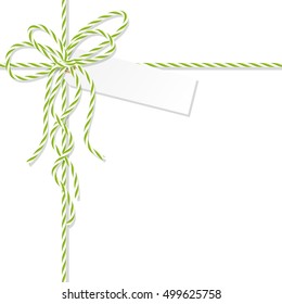 Abstract white background with tag label tied up with green rope bakers twine bow and ribbons