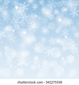 Abstract winter background with blurred various snowflakes.