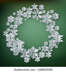 Abstract winter background with paper snowflakes on green background. EPS 10