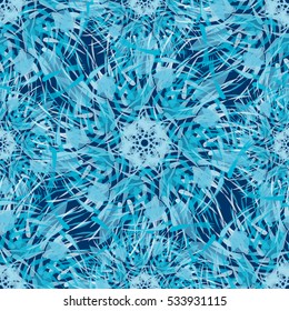 Abstract winter geometrical seamless pattern with blue mandalas or complicated snowflakes.