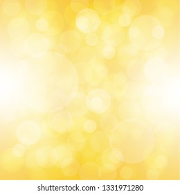 Abstract yellow background with light bokeh.
