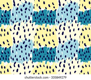 Abstract yellow and blue patches with black dots.Hand drawn with paint brush seamless background.Modern hipster style design.