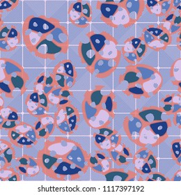 Abstraction. Seamless color pattern made up of multi-colored rounded elements with holes. Under the picture is a background consisting of rounded squares formed by diagonal lines.