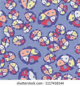 Abstraction. Seamless color pattern made up of multi-colored rounded elements with holes. The picture is superimposed on a background consisting of small mutually perpendicular ovals.