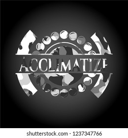 Acclimatize written on a grey camouflage texture