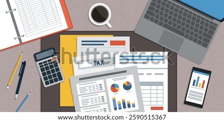 Accountant sitting at the office desk and checking financial reports, desktop top view