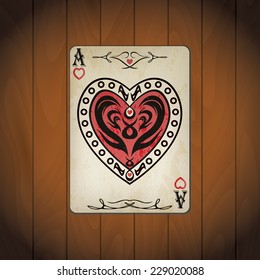 Ace of hearts poker card old look on lacquer wood background