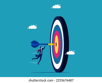 Achieve your goals. Businessman throwing darts into the target