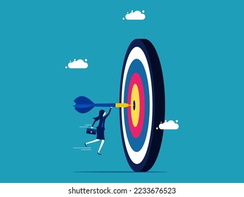 Achieve your goals. Businesswoman throwing darts into the target