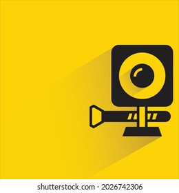 action camera with shadow on yellow background