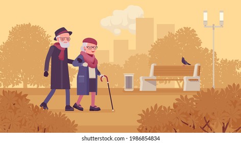 Active seniors, happy healthy elderly people walking through the autumn park. Couple of older adults enjoying together outdoor park promenade arm in arm. Beautiful fall nature scenery background