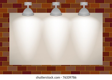 Ad space on the brick wall illuminated with three spotlights