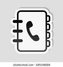 address book with phone sign on cover. simple icon. linear symbol with thin outline. Sticker style with white border and simple shadow on gray background