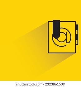 address book with shadow on yellow background