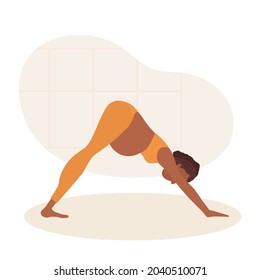 Adho Mukha Shvanasana. Pregnant African American woman doing yoga. Woman in sportswear makes downward facing dog pose. Women healthy life style concept. Prenatal Adho Mukha Shvanasana.