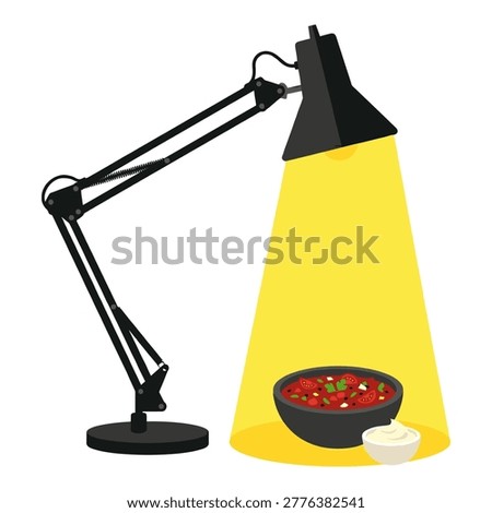 Adjustable desk lamp casting a warm light on a bowl of salsa and a dish of sour cream, evening snack concept.