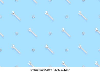 Adjustable metal wrench seamless pattern. Background from a metal wrench and nut. 