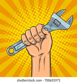 Adjustable wrench in hand pop art style vector illustration. Comic book style imitation