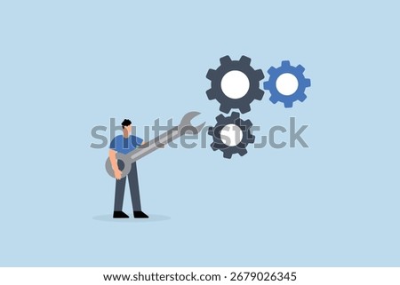 Adjustment and optimization for business improvement, entrepreneur grasping wrench to modify gear cogwheels configuration.