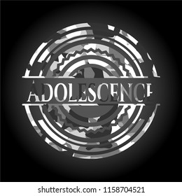 Adolescence written on a grey camouflage texture